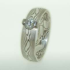 18k white gold and silver mokume gane band with brilliant cut diamond in 18k white gold bar setting