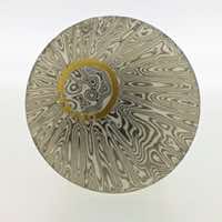 Radiant patterned 18k white gold and silver mokume gane discus brooch with 22k gold halo and diamond detail. 