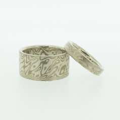 18k white gold and silver mokume gane flat bands.  Please go to online shop for prices.