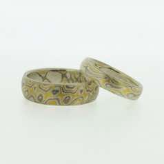 22k gold, 18k white gold and silver mokume gane full court bands.  Please go to online shop for prices.