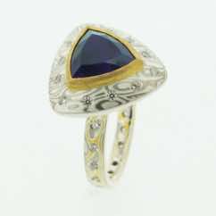 22k gold, 18k white gold and silver mokume gane 3mm flat band with flush set diamonds with a trillion amethyst set in a 22k gold setting on an 18k white gold and silver mokume gane rouleaux shaped pod. 