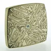 Torsion patterned 18k white gold and silver mokume gane fower neukit brooch with diamond detail. 