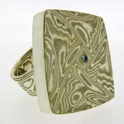 Torsion Ring in 18k white gold and silver with diamond detail.  POA. 