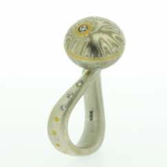 18k white gold and silver sphere with 22k gold and diamond detail on sterling silver curved band with diamonds. 