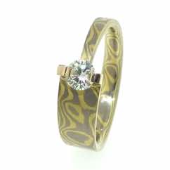 18k white and yellow gold mokume gane tapered band with brilliant cut diamond in 18k gold bar setting