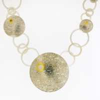 18k white gold and silver mokume gane 'Puckle' discus necklace with 22k gold and diamond details.  POA.