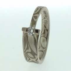 18k white gold and silver mokume gane tapered band with brilliant cut diamond in 18k white gold bar setting