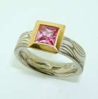 18k white gold and silver mokume gane flat band with a square facet-cut pink sapphire in a 22k gold rub-over box pod setting