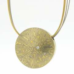 18k white and yellow gold mokume gane discus pendant with flush set diamonds and 22k gold details. 