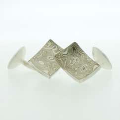 18k white gold and silver mokume gane concave rectangular cufflinks with sterling silver rod and back.