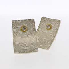 18k white gold and silver rectangular studs with diamonds set in low 22k gold settings.