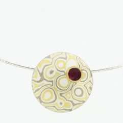 22k gold, 18k white gold and silver mokume gane discus pendant with a ruby set in 22k gold.  