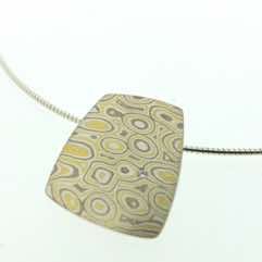 22k gold, 18k white gold and silver mokume gane medium fower neukit pendant with flush set diamond. 