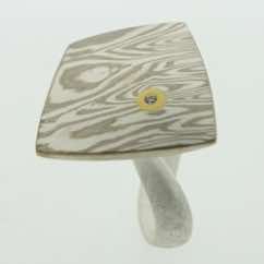 18k white gold and silver mokume gane fower neukit with 22k gold and diamond details presented on a sterling silver curved band.