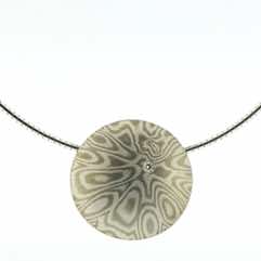 18k white gold and silver mokume gane discus pendant with diamond detail.  