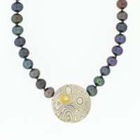 4mm peacock pearls with central discus (15mmø) in 22k gold, 18k white gold and silver mokume gane with 22k gold and diamond details.  POA.