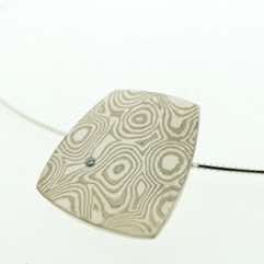 18k white gold and silver mokume gane medium fower neukit pendant with flush set diamond.  