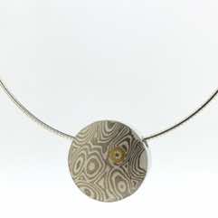 18k white gold and silver mokume gane small discus pendant with 22k gold and diamond detail.  