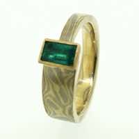 18k white and yellow gold mokume gane tapered band with a customer's own gemstone in a 22k yellow gold rub-over box setting