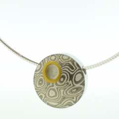 18k white gold and silver mokume gane discus pendant with 22k gold cutaway and diamond detail. 