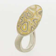 22k gold, 18k white gold and silver mokume gane oval form presented on a sterling silver curved band.