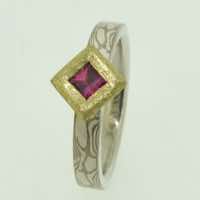 18k white gold and silver mokume gane flat band with a square facet-cut ruby in a 22k gold rub-over box pod setting with frosted finish