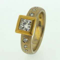 18k white gold and 22k yellow gold mokume gane full court band with flush set diamonds and a princess cut diamond in a 22k gold box setting