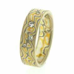 22k gold, 18k white gold and silver mokume gane 6mm flat band with four brilliant cut diamonds in a random scatter.<br/>