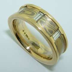 18k white and yellow gold mokume gane flat band with 18k yellow gold rails set with 3 small baguette diamonds