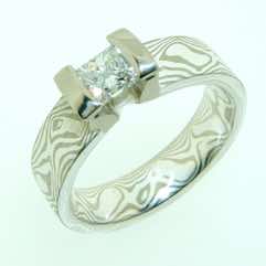 18k white gold and silver mokume gane 5mm flat band with a 0.35ct princess cut diamond in an 18k white gold double bar setting