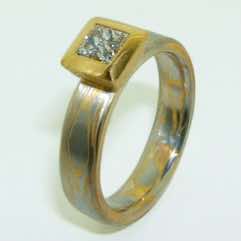 Platinum and 22k gold mokume gane flat band with a princess cut diamond in a 22k gold box setting