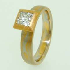 Platinum and 22k gold mokume gane band with a princess cut diamond in a 22k gold  frosted box setting