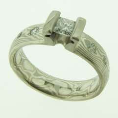 18k white gold and silver mokume gane 5mm full court band with flush set diamonds and a princess cut diamond in an 18k white gold double bar setting