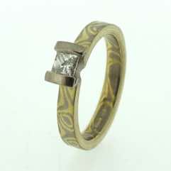 18k white and yellow gold mokume gane 3mm flat band with a princess cut diamond in an 18k white gold double bar setting