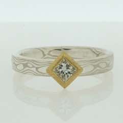 18k white gold and silver mokume gane 3mm flat band with a princess cut diamond in a frosted 22k gold box setting