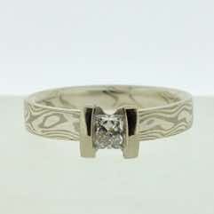 18k white gold and silver mokume gane 3mm flat band with a princess cut diamond in an 18k white gold double bar setting