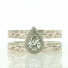 Double band in 18k white gold and silver mokume gane with pear shaped diamond in frosted white gold setting
