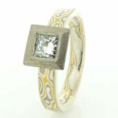 Flat band in 22k gold, 18k white gold and silver mokume gane with princess cut diamond in a frosted 18k white gold setting