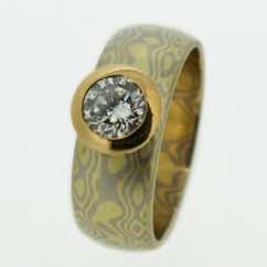 18k white and yellow gold mokume gane wide band with brilliant cut diamond in 22k gold tapered rubover setting