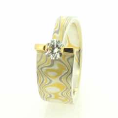 22k gold, 18k white gold and silver mokume gane wide tapered band with brilliant cut diamond in 22k gold bar setting